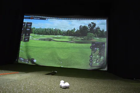 Indoor golf simulator turned on to the green